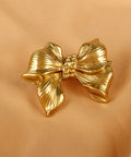 Gold Bow Cabinet Knobs Set Two Pack Brass Finish Bow Shaped Pulls, shown on a satin background.