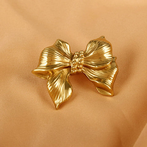 Gold Bow Cabinet Knobs Set Two Pack Brass Finish Bow Shaped Pulls, shown on a satin background.