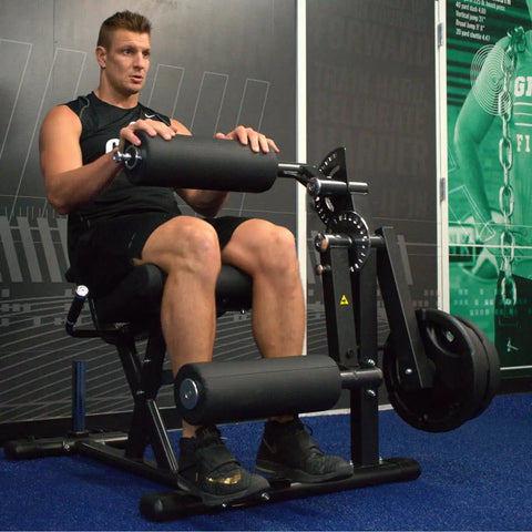 Man using Plate Loaded Leg Extension And Curl Machine For Home Gym Seated Leg Curl And Quad Extension With 180 Lb Plate Load