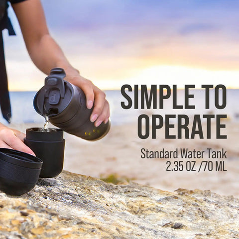 Person using Minipresso GR Portable Espresso Machine For Ground Coffee, Manual Hand Press Coffee Maker, outdoors on rock
