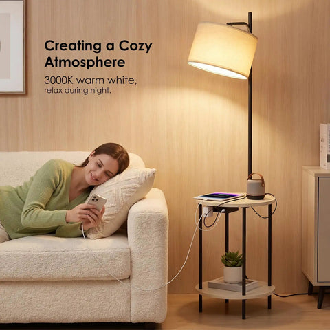 Space Saving Floor Lamp With Built In Round Table And USB Type C And USB A Charging Ports 9W LED Bulb Nightstand For Bedroom And Living Room White Ideal For Cozy Corners And Small Spaces next to a sofa