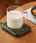 Smart Home Cup Warmer Heating Plate With Smart Temp Control Keeps Your Daily Sips Locked And Toasty Auto Shutoff Safety Feature 25 Watt Energy Savers Green Coaster Drink Heater For Coffee And Milk Tea with steaming cup of milk on desk