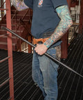 Person holding Made in USA Round 7/8 Inch by 36 Inch Connecting Bar For Solid Aligning Prying And Chiseling Ergonomic Pro Grade Sleever Bar