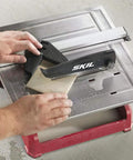 Heavy Hitter 7 Inch Wet Tile Saw With Rust Proof Stainless Top And Adjustable Rip Fence, cutting tile with water tray.