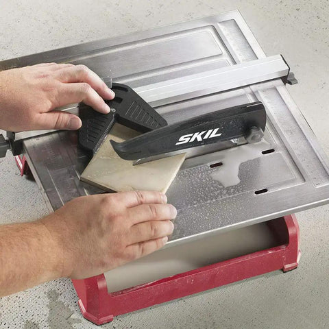 Heavy Hitter 7 Inch Wet Tile Saw With Rust Proof Stainless Top And Adjustable Rip Fence, cutting tile with water tray.