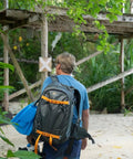 Person wearing Whistler 350 AW II Camera Backpack With Top And Body Access Gray Expanding Interior Fits 3 Lenses outdoors