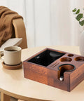 Espresso tamping station with wooden holder and compartment for tools, enhancing home cafe setup. Level Up Your Pour With This Espresso Tamping Station Featuring A Heavy Duty Coffee Tamper Holder And Powder Distributor. Non Slip Rubber Base Keeps Mess At Bay. Absolute Game Changer For Home Cafe Setup.