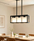 ROCUNSI 3-Light Black Kitchen Island Lighting above a dining table, featuring three glass shades and a modern design.