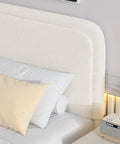 Snug Twin Bed Frame With Ultra Soft Cloud Boucle Fabric And Cream Upholstered Headboard featuring smooth rounded corners and pillows.