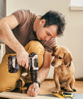 Man using 20V Cordless Drill Kit With 100 PC Drill Bit Set And 3 Eighths Inch Keyless Chuck LED Light, dog watching