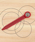 Heavy Duty Aluminum Circle Maker Compass For Woodworking And Carpentry measuring circles on a wooden surface with steel ball bearing.