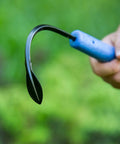 Close-up of the Classic Weeder And Cultivator Garden Go To Hand Tool with forged steel blade and recycled plastic handle in use.