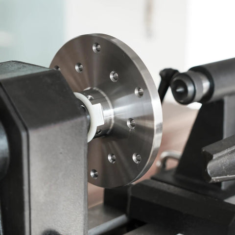 Close-up of Heavy Duty 1x8Tpi Face Plate Kit For Woodturning Lathes, showcasing the metal disc mounted on a lathe.