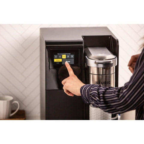 Person using touchscreen on K-3500 Single Serve Commercial Coffee Maker For Busy Offices, 150 Plus Pod Varieties.
