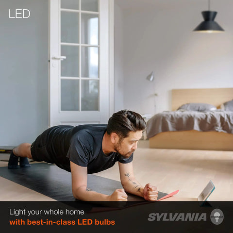 Man exercising in bedroom with LED lighting, showcasing LED A19 Light Bulb 60W Equivalent 9W Energy Efficient 800 Lumens Soft White