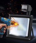 JUDYSSY Solar Flood Lights 20W Warm White Led Spotlight with Motion, showing installation with power drill.