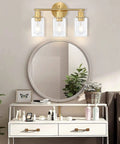 Three Light Matte Black Vanity Light With Clear Glass Shades For Bathroom Modern Wall Sconce Over Mirror With Adjustable Up Or Down Mount Sleek Vanity Fixture Delivering Bright On Trend Illumination in a modern bathroom setting