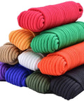 Stack of colorful ropes next to heavy duty polyester rope 100 feet three eighth inch diamond braid all purpose utility cord white.