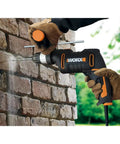 Heavy Duty 600 Watt Impact Drill Driver With 13 Mm Keyless Chuck And Variable Speed Control drilling into brick wall.