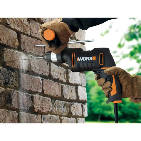 Heavy Duty 600 Watt Impact Drill Driver With 13 Mm Keyless Chuck And Variable Speed Control drilling into brick wall.