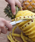 Person using V Shape Stainless Steel Pineapple Eye Peeler Remover Tool for Easy Home Kitchen Prep, removing eyes from pineapple.