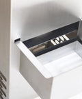 Close-up of automatic deep fryer oil filter's stainless steel compartment, designed for busy restaurants to remove gunk.