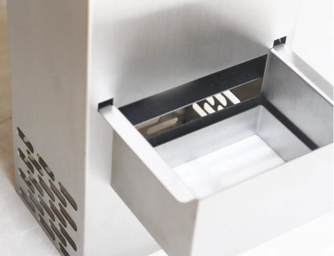 Close-up of automatic deep fryer oil filter's stainless steel compartment, designed for busy restaurants to remove gunk.