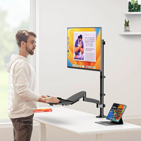 Premium Ergonomic Sit Stand Monitor Desk Mount With Wide Keyboard Tray For 17 To 32 Inch Screens delivering super slick pneumatic spring height adjustment tech in use.