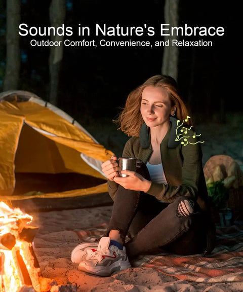 Person enjoying Wireless Neckband Speaker With 360 Degree Surround Sound by a campfire, showcasing outdoor use.
