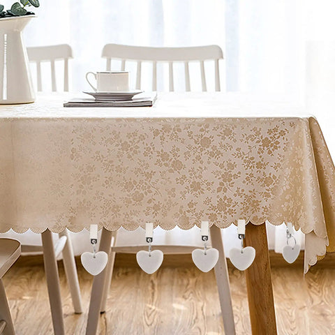 Table with 12 pieces white heart shaped stone tablecloth weights with metal clips, showing marble decor and floral cloth.