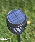 Top view of P2 Solar Flickering Flame Torch Light With Realistic Fire showing solar panel and lampshade, grass background.