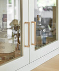 10 Pack Classic Solid Cabinet Handles Set 6.3 Inch Screw Spacing in Champagne Bronze installed on glass cabinet doors