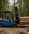 Heavy Duty Side Loading Electric Forklift With 5000 Lb Capacity And Quick Charge Lithium Ion Battery carrying logs in forest.