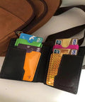 16 Piece RFID Blocking Sleeve Set With 12 Colorful Credit Card Protectors and a wallet beside a travel bag