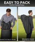 Man packing and carrying oversized double camping chair with padded seats in a cinch bag, heavy duty outdoor lawn chair for 600 pounds.