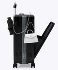 Luggage: side view of medium black aluminum-frame suitcase with white handbag attached to top handle.