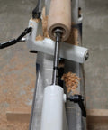Close-up of a wood lathe with a wooden workpiece and shavings, demonstrating use of Premium Four Piece Forstner Bit Set Built For No Headache Splinter Free Cuts With Fischers Edge Design And True Size Accuracy Across Softwood And Hardwood While Dropping Ten Times More Holes Than Old School Bits For Sweet Finish Work.
