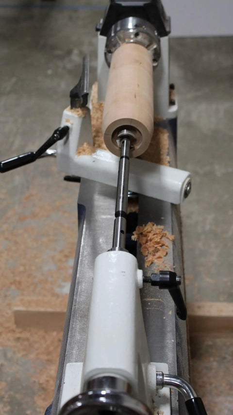 Close-up of a wood lathe with a wooden workpiece and shavings, demonstrating use of Premium Four Piece Forstner Bit Set Built For No Headache Splinter Free Cuts With Fischers Edge Design And True Size Accuracy Across Softwood And Hardwood While Dropping Ten Times More Holes Than Old School Bits For Sweet Finish Work.