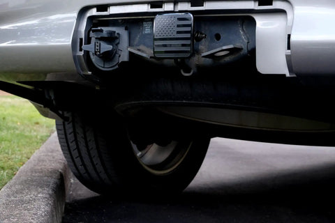 Car with 2 Inch Trailer Hitch Cover Plug With Metal American Black Flag Universal Fit For Any 2 Inch Hitch Receiver, rear view.