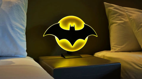 Batman Night Light Table Lamp With 3D Halo Glow, Mountable Bat Sign Wall Light on a bedside table, dimly lit room