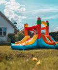 Inflatable bounce house in yard with visible Beefy Heavy Duty Ground Anchor Screws in 4 pack with nuts and tool spiral trampoline anchors.