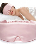 Woman wearing 100 Percent Mulberry Silk Sleep Mask For Women Adjustable Comfort Side Sleeper Friendly Full Blackout Eye Cover For All Night Sleep Travel Office Or Naps Pink in bed, shown close-up.