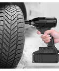 Gangsuqd Brushless Impact Wrench in use on a tire for car repairs, showcasing its cordless design and high torque efficiency.