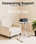 Adjustable Height Rolling Standing Desk With Locked Down Casters And Swivel Surface Lightweight Mobile Laptop Table For Home Office Over Bed No Sweat Assembly Slick White Finish beside a chair.