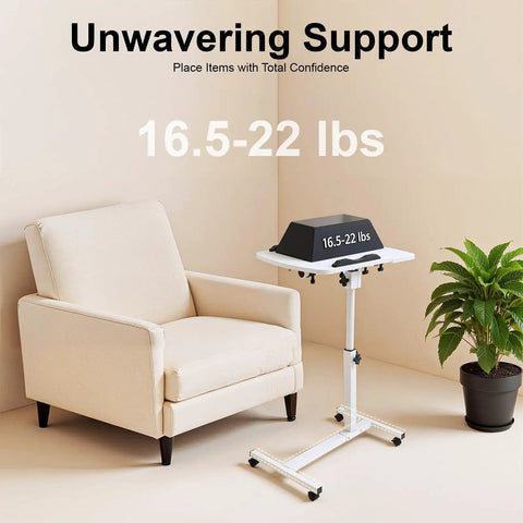 Adjustable Height Rolling Standing Desk With Locked Down Casters And Swivel Surface Lightweight Mobile Laptop Table For Home Office Over Bed No Sweat Assembly Slick White Finish beside a chair.