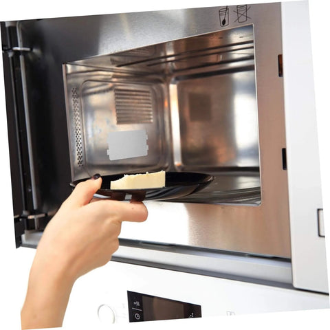 Inserting food into microwave with 10 Piece Microwave Mica Insulation Sheets for easy, heat-resistant waveguide cover replacement.