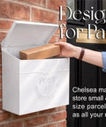 Outdoor Wall Mount Mailbox 11.5 x 5 x 13 Inches White Waterproof Heavy Duty Metal Mailbox For Outside Built To Last Modern Wall Mounted Door Mailbox Weatherproof Chelsea Style Box With Secure Slot shown holding package
