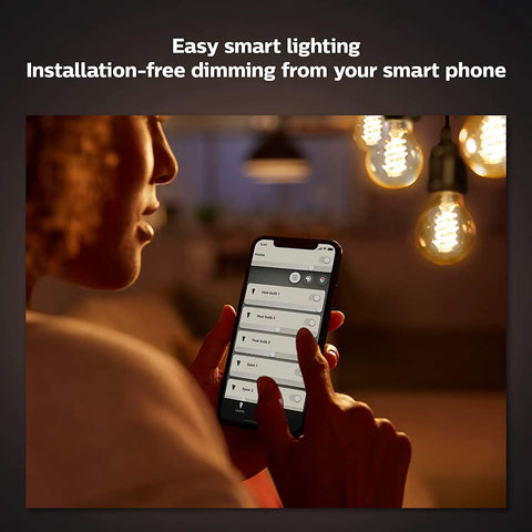 Person using smartphone app to control Smart Filament LED Bulbs White A19 Edison Style Two Pack For Vintage Look With Modern Vibe Mood Lighting