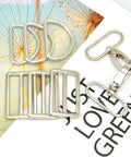 15 Piece Top Shelf Metal Swivel Snap Hooks And D Rings With Tri Glide Slide Buckles For Lanyard Purse Bag Straps And Dog Collars Straight Up DIY Sewing Hardware Kit In Smooth Silver displayed on a background.