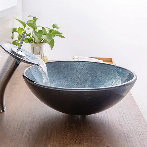 USZWBY Blue Bathroom Vessel Sink, Round 16.5" Tempered Glass Vessel Vanity Sink with waterfall faucet in a modern setting.